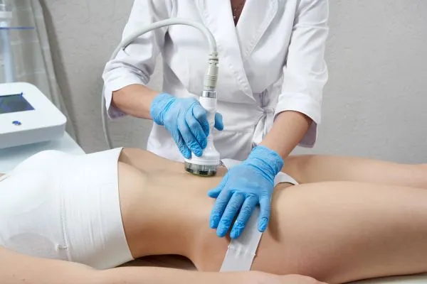 Lost the Weight but Not the Loose Skin? 2 woman having HIFU treatment on her stomach to combat loose skin Henley-on-Thames following weight loss